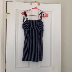Navy blue dress with thin white stripes.